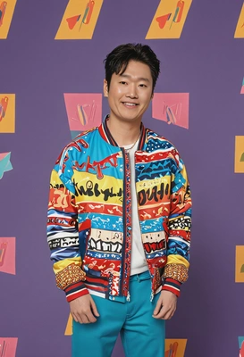 as a K-pop idol, dressed in a colorful, patterned bomber jacket and high-top sneakers, filming a high-energy music video in a retro-inspired set