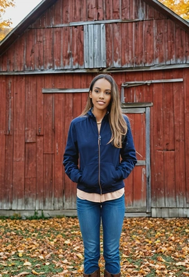 standing in front of a rustic barn surrounded by autumn colors