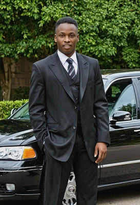 near a classic black limousine 