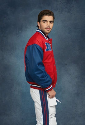 as a 90s high school quarterback, dressed in a red letterman jacket, confidently posing against a traditional murky blue yearbook background