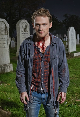 zombie with tattered clothes and fake blood, standing in a night graveyard