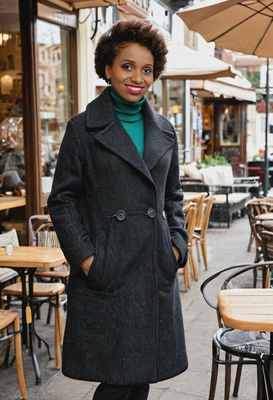in a wool coat, standing by a cozy outdoor café