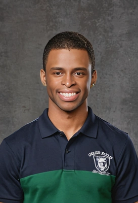 student with a middle part, in a rugby polo shirt, giving a subdued yet friendly grin, yearbook background 