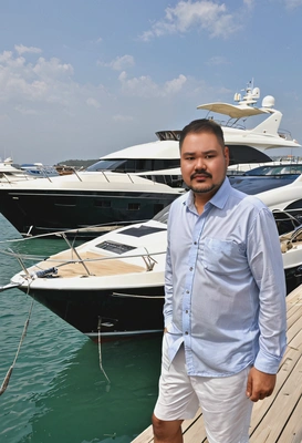 on a private dock, with a luxury yacht on the background